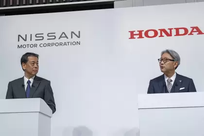 Toshihiro Mibe de Honda habla y Makoto Uchida de Nissan, escucha.